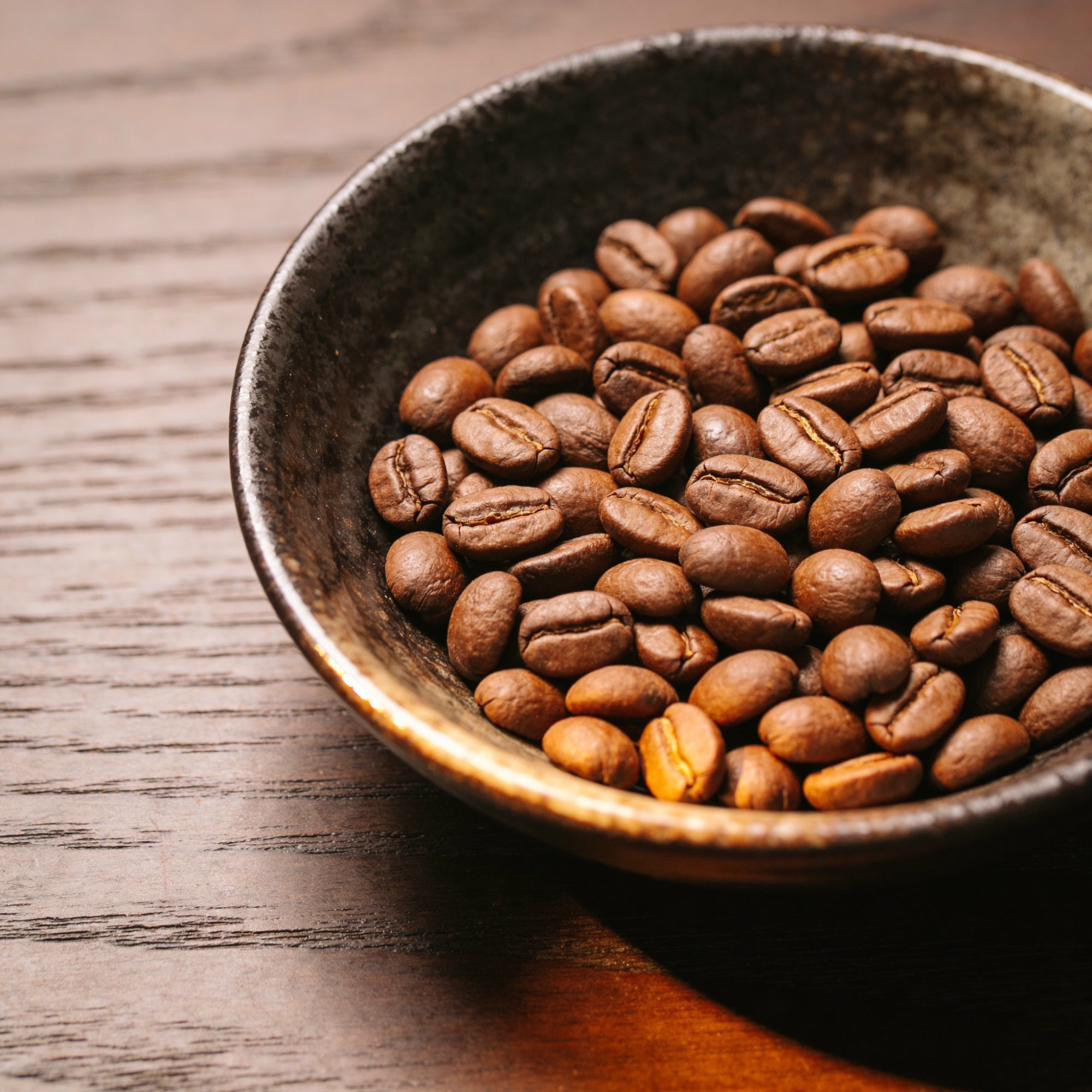 Macro shot of roasted whole beans in a stoneware bowl
